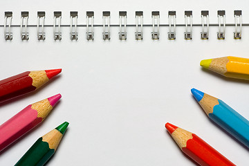 Image showing Color pencils on a notepad

