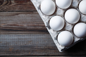 Image showing White eggs on a rustic wooden table