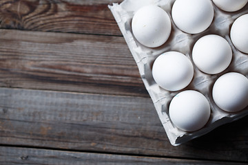 Image showing White eggs on a rustic wooden table