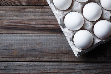 Image showing White eggs on a rustic wooden table