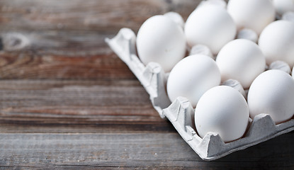 Image showing White eggs on a rustic wooden table