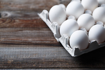 Image showing White eggs on a rustic wooden table