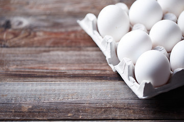 Image showing White eggs on a rustic wooden table