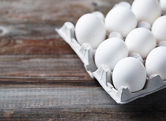 Image showing White eggs on a rustic wooden table