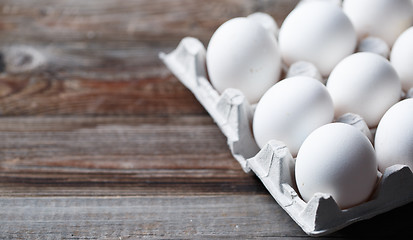 Image showing White eggs on a rustic wooden table