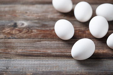 Image showing White eggs on a rustic wooden table