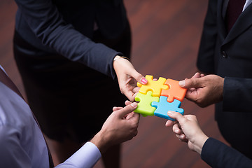 Image showing top view of business people group assembling jigsaw puzzle