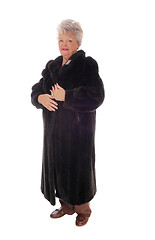 Image showing Senior woman standing in fur coat.