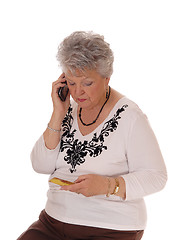 Image showing Senior woman buying over phone.