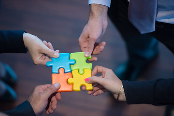 Image showing top view of business people group assembling jigsaw puzzle