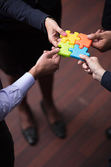 Image showing top view of business people group assembling jigsaw puzzle