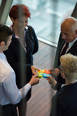 Image showing top view of business people group assembling jigsaw puzzle