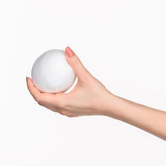 Image showing The female hand holding white blank styrofoam oval 