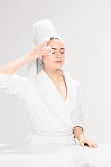 Image showing Woman cleaning face in bathroom