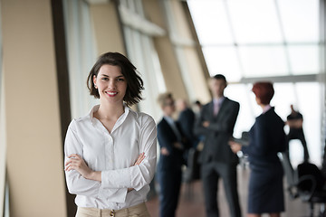 Image showing young business woman in front her team