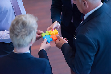 Image showing top view of business people group assembling jigsaw puzzle