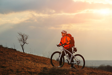 Image showing Man cyclist with backpack riding the bicycle