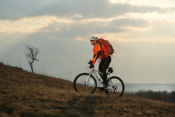 Image showing Man cyclist with backpack riding the bicycle