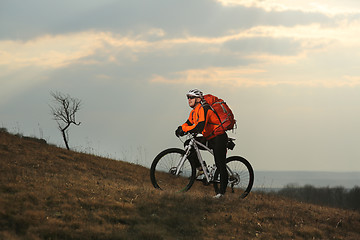 Image showing Man cyclist with backpack riding the bicycle