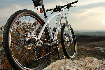 Image showing Bicycle stands on a rock