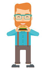 Image showing Man eating hamburger. 