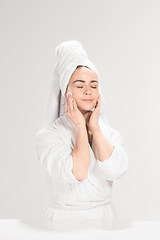 Image showing Woman cleaning face in bathroom