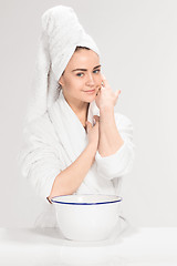 Image showing Woman cleaning face in bathroom