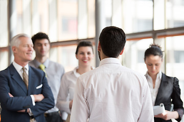 Image showing young startup businessman making presentation to senior investio