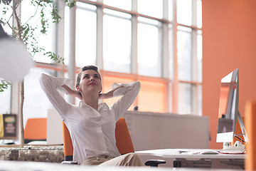 Image showing happy young business woman relaxing and geting insiration