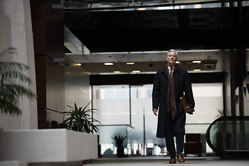 Image showing handsome senior business man walking