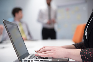 Image showing young business woman on meeting  using laptop computer