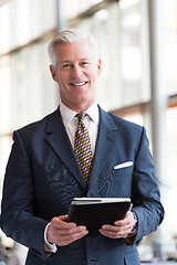 Image showing senior business man working on tablet computer