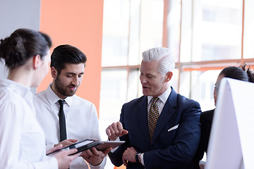 Image showing young startup businessman making presentation to senior investio