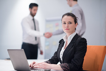 Image showing young business woman on meeting  using laptop computer