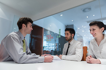 Image showing young couple signing contract documents on partners back