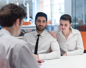 Image showing young couple signing contract documents on partners back