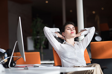 Image showing happy young business woman relaxing and geting insiration