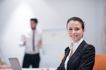 Image showing young business woman on meeting  using laptop computer