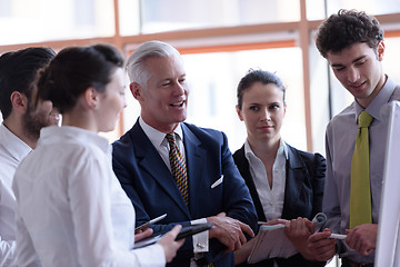 Image showing young startup businessman making presentation to senior investio