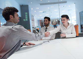 Image showing young couple signing contract documents on partners back