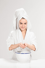 Image showing Woman cleaning face in bathroom