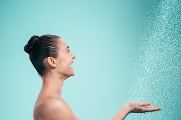 Image showing Woman enjoying water in the shower under a jet