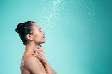 Image showing Woman enjoying water in the shower under a jet