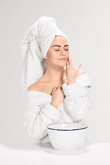 Image showing Woman cleaning face in bathroom