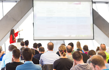 Image showing Female speeker having talk at public event.