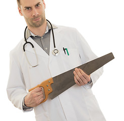 Image showing Crazy doctor is holding a big saw in his hands