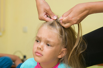 Image showing  Girl hurt when her long hair braided