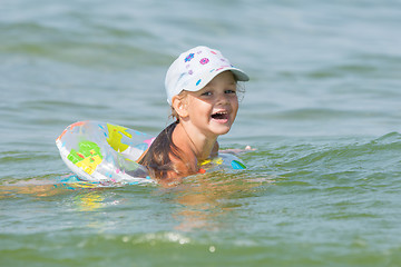 Image showing Joyful little girl swimming in a pond at the children\'s circle