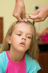 Image showing The girl with a tortured expression braided long hair