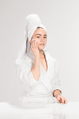 Image showing Woman cleaning face in bathroom